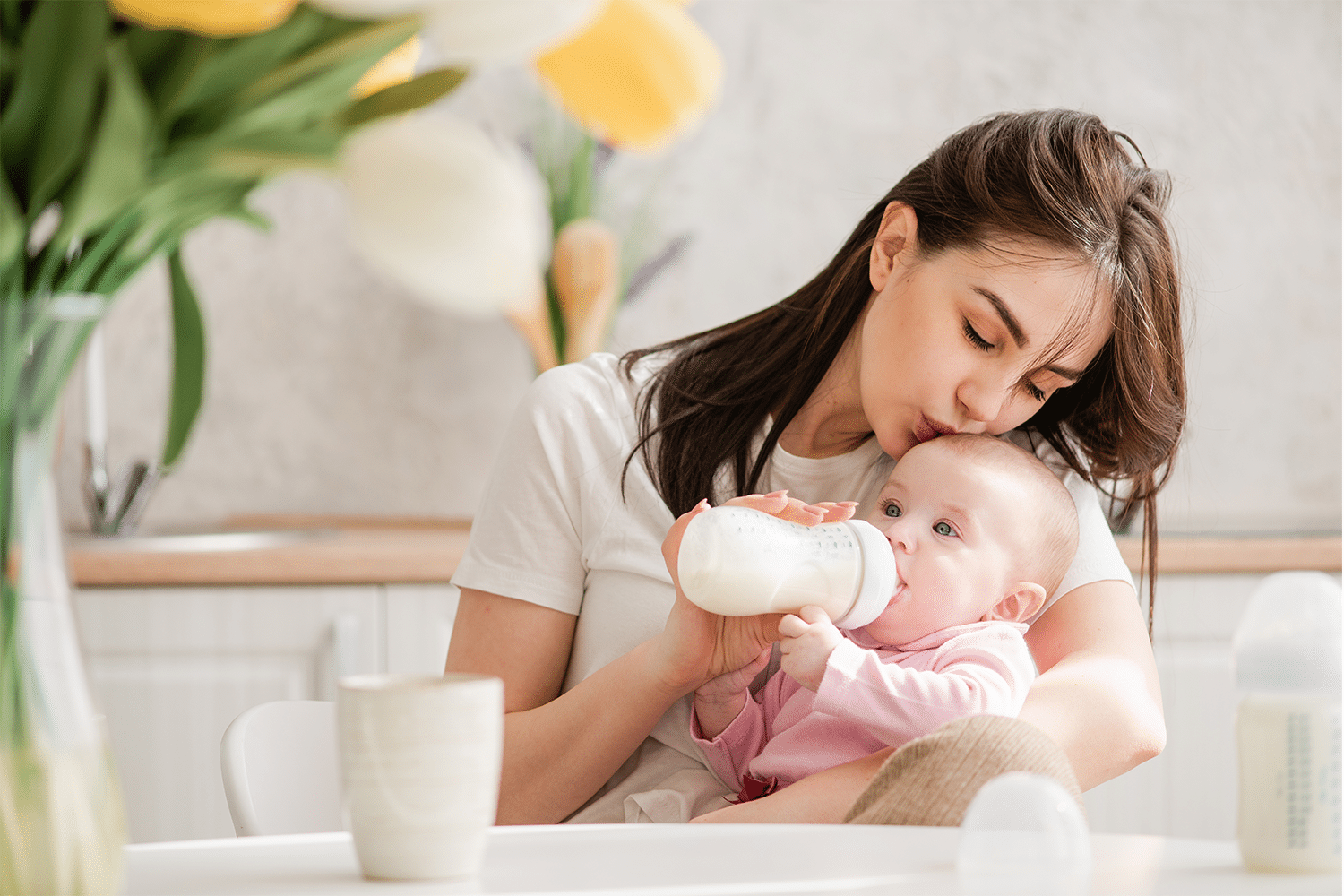 Mum feeding baby in garden