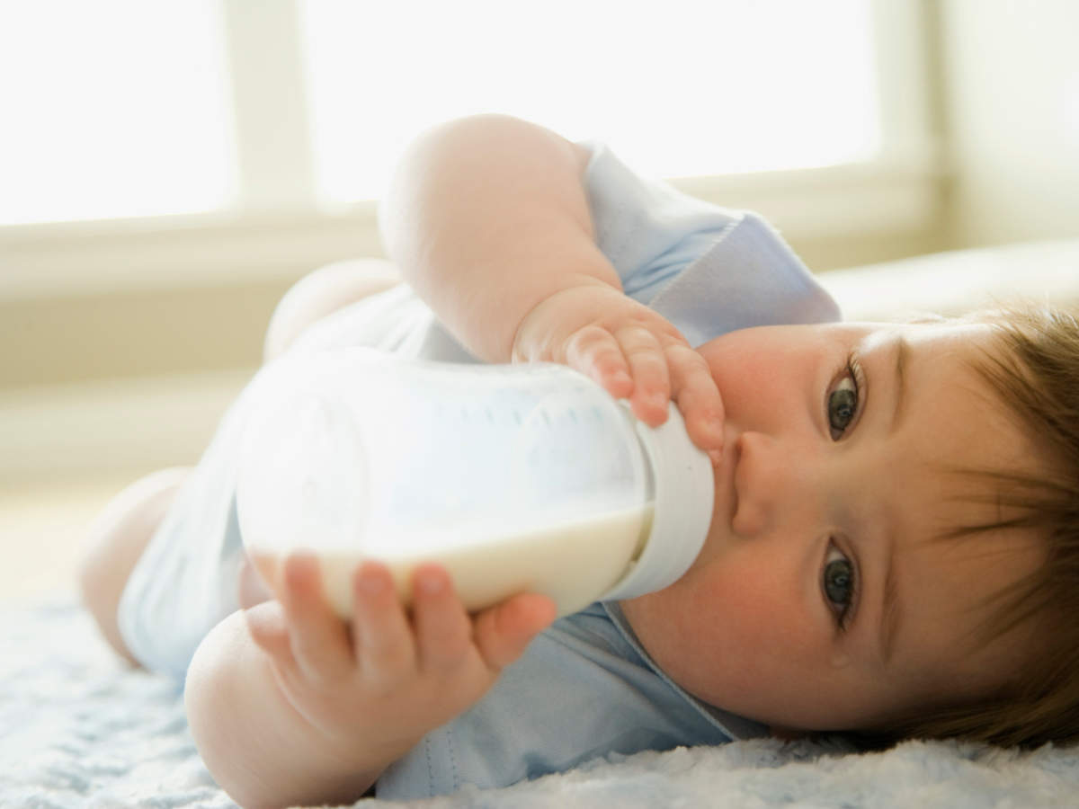 Little boy holding Nannycare growing up milk tin