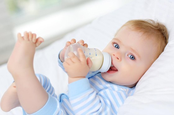 Little girl holding Nannycare follow on milk 